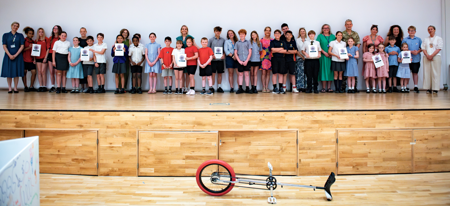 More than 100 children from Armed Forces families came together at Tidworth Garrison Theatre to celebrate the success of a year-long project designed to strengthen support for Service children in Wiltshire schools. The project, funded by the Armed Forces Education Trust and supported by Wiltshire Council, has engaged 42 schools since October 2025, benefiting thousands of children from Armed Forces families. Throughout the academic year, schools have been working to better understand and respond to the unique experiences and challenges faced by Service children. A celebration event brought together around 140 children aged seven to 14 from 24 of the participating schools. Pupils had the opportunity to showcase their work, take part in fun workshops, share what they had learned and celebrate the progress their schools have made in supporting Armed Forces families. Displays from all participating schools were featured as part of the event, highlighting a range of initiatives and activities developed during the project. Certificates were presented to recognise the commitment and achievements of the children and schools involved. Cllr Jon Hubbard, Wiltshire Council Cabinet Member for Education and Skills, said: "This was a fantastic opportunity to see so many young people gathered together to celebrate their achievements and showcase the work they have been involved in throughout the year. The displays demonstrated the creativity, enthusiasm, and commitment of both the pupils and school staff who have embraced this project. "Wiltshire has a significant Armed Forces community and it is important that our schools understand and respond to the experiences of Service children, who can face unique challenges as a result of family mobility, deployment and change. This project has helped schools strengthen the support they provide and ensure Service children feel understood, valued and able to thrive. I would like to congratulate all the children who took part, thank the schools for their commitment and recognise the valuable support of the Armed Forces Education Trust in making this project possible." Charmian Hickman, Chief Executive Officer, Armed Forces Education Trust said: “The Wiltshire Festival of Friends has been a great example of what can be achieved when schools, local authorities and partners work together to support Service children. By connecting pupils with shared experiences, building staff expertise and strengthening collaboration across schools, the project has created a lasting legacy that will benefit military families across Wiltshire. We are delighted to have enabled such a successful initiative and congratulate all who took part on the difference they have made.” Kerry Parker, Headteacher at Corsham Primary School said: “Friday’s Military Festival of Friends was a powerful reminder of what community looks like at its best. For our children, it wasn’t just an event - it was a chance to understand service, resilience, and the importance of connection. The opportunity to meet children, hear their stories, and take part in shared activities has already sparked thoughtful conversations back in school. It has meant a great deal to our children too. The event strengthened our links with the military community and helped our pupils see the real people behind the uniforms. The impact has been both educational and deeply human, and we’re proud to have been part of it.” Chantell Knight Service Champion Kingdown School said: “"The Festival of Friends has been an invaluable opportunity for our school to celebrate and support our service children. Through collaboration with other schools, we have developed new ideas, strengthened our provision, and built a community that recognises the unique experiences of military families. Most importantly, it has helped us ensure that every service child feels connected, valued, and supported throughout their time with us." The project will continue beyond the celebration event, with schools now developing case studies of the improvements they have made to support Service children. These will be brought together in a digital booklet, due to be published in the autumn, enabling schools across Wiltshire and beyond to share learning and best practice. Wiltshire Council would like to thank all participating schools, pupils, families and partners who have supported the project and contributed to its success.
